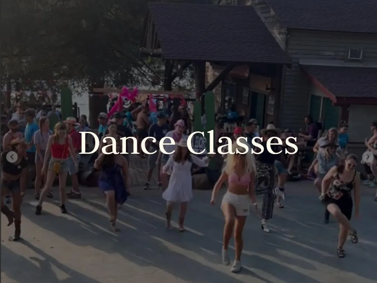 A crowd learns a dance routine outdoors