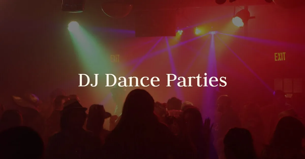 A crowd dances under red and green party lights