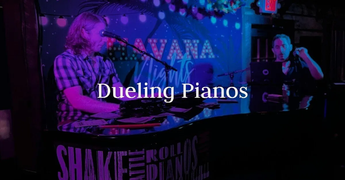 Pianists entertain a crowd under purple lights