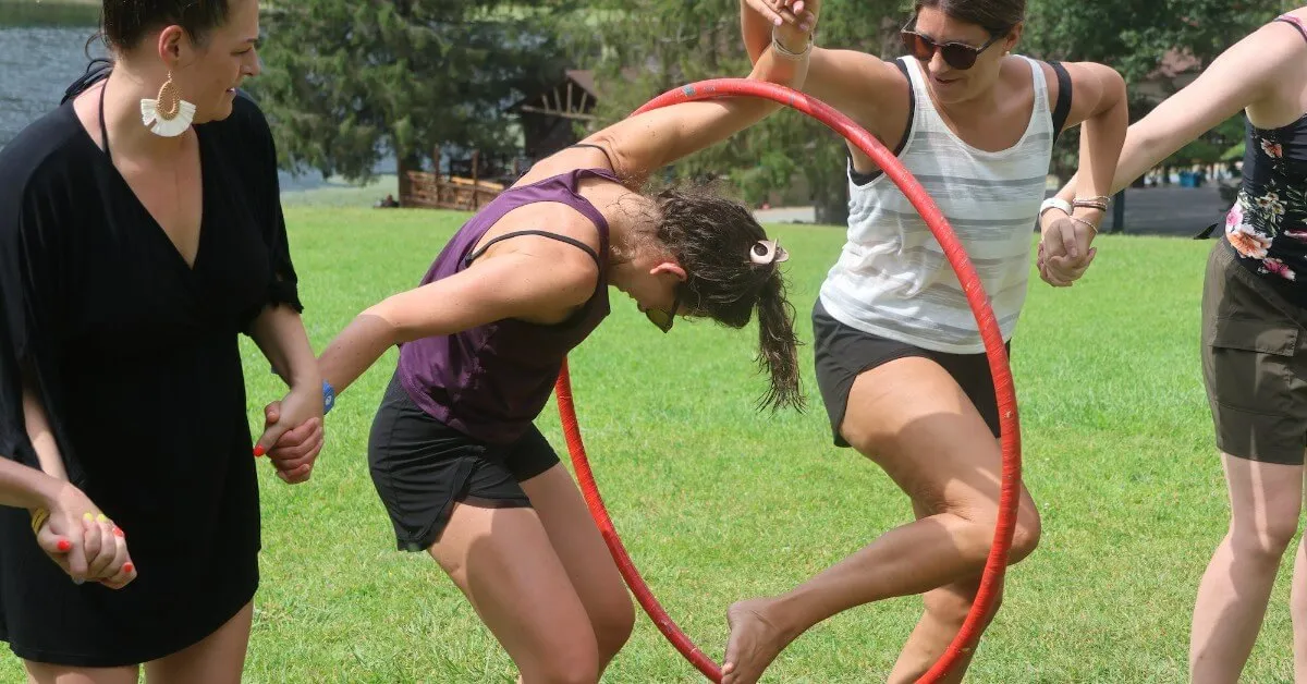 Two guests race to pass a hula hoop down their line