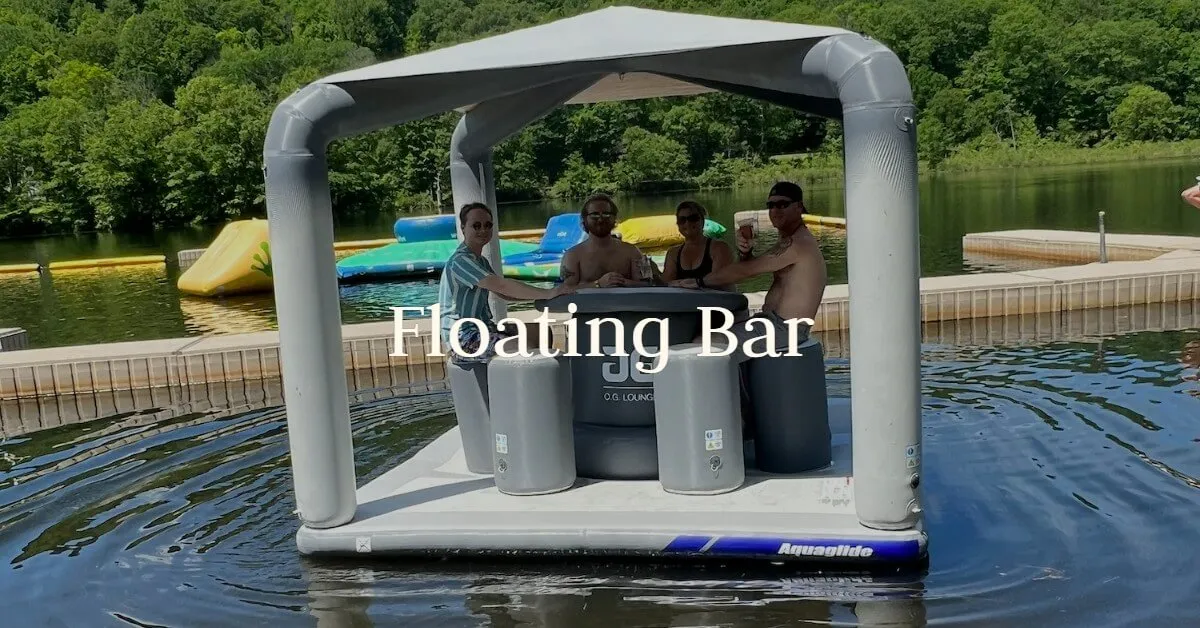 Guests gather under the canopy of a floating table and chairs on the lake