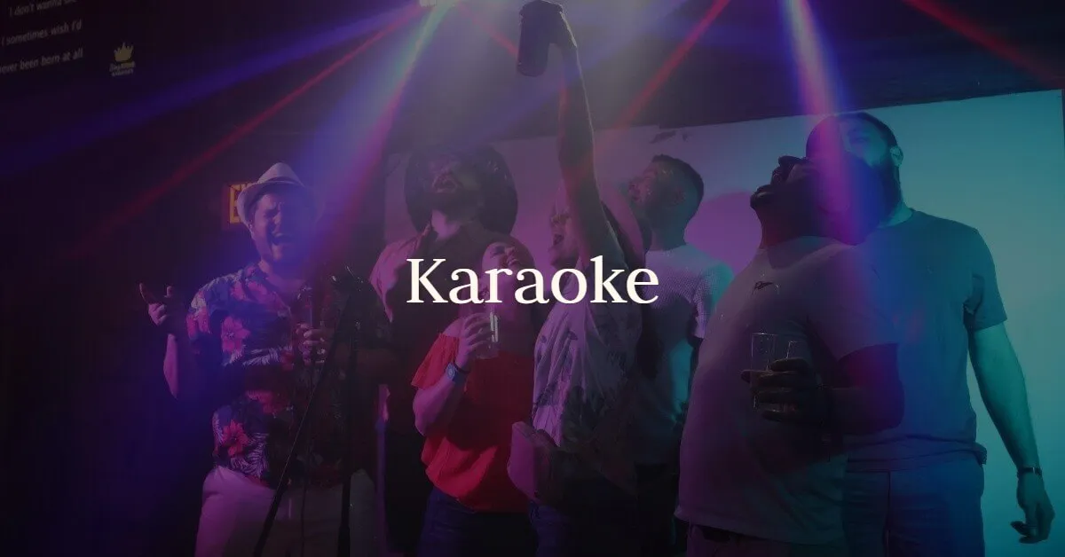Guests sing karaoke under colorful stage lights